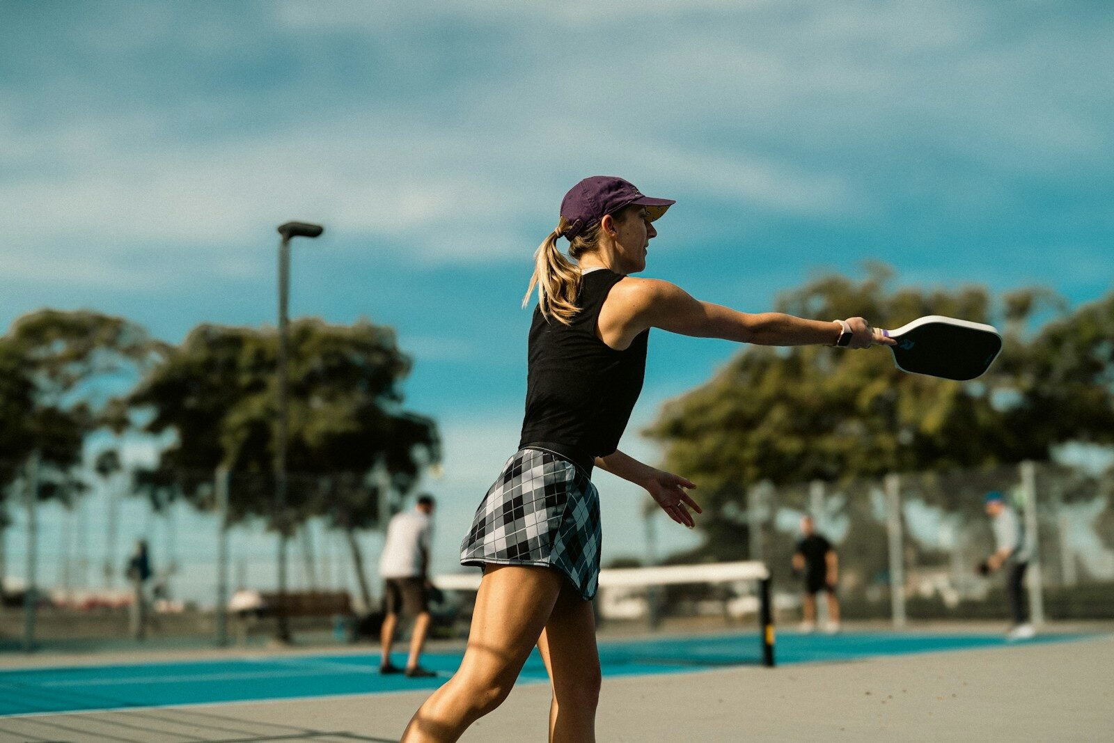 A woman is playing tennis on a court